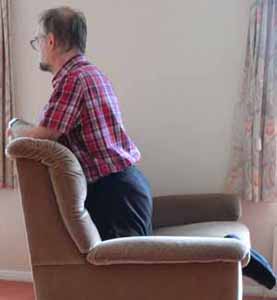 kneeling on a sofa